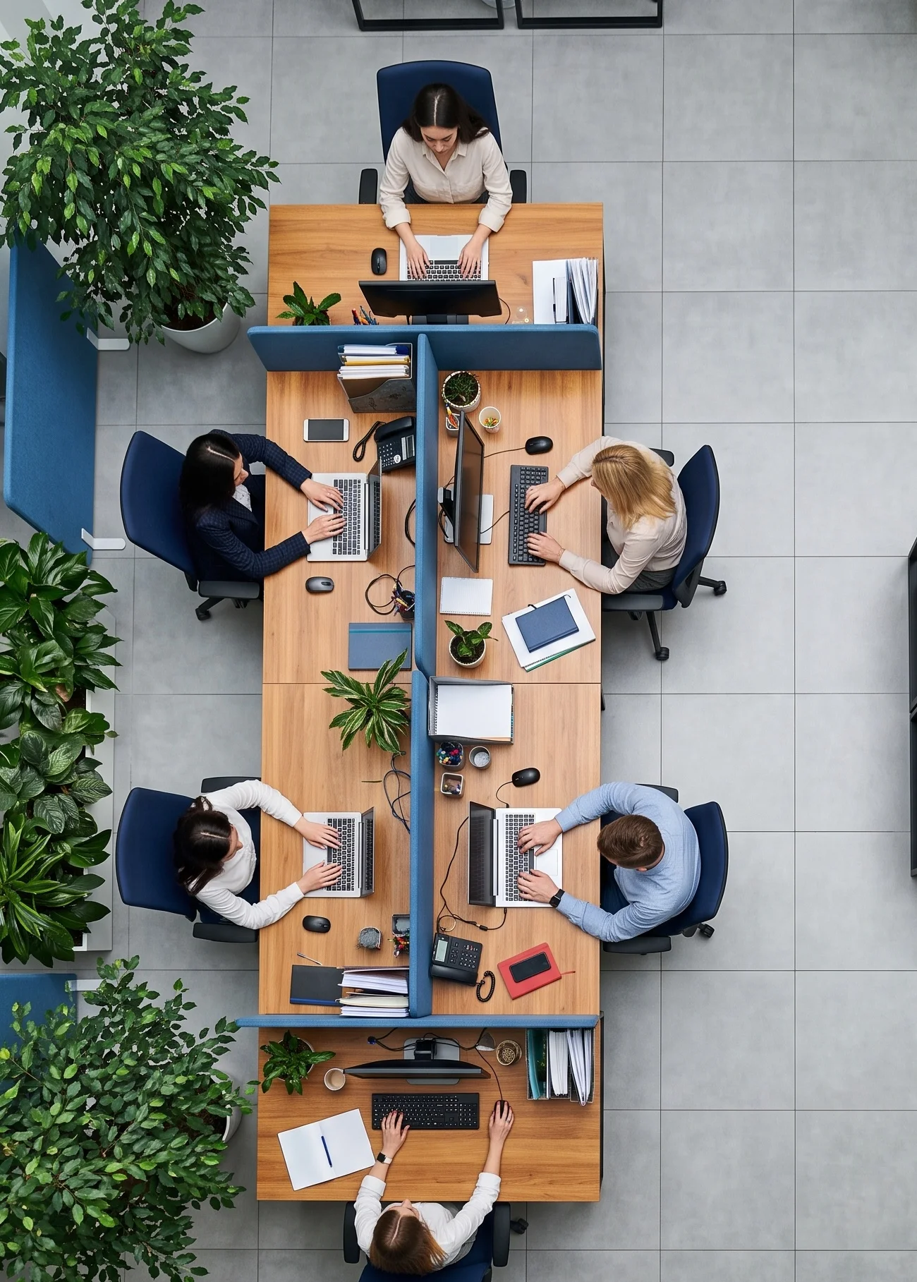 Overhead view of a team working together at desks in an AI-enabled office environment